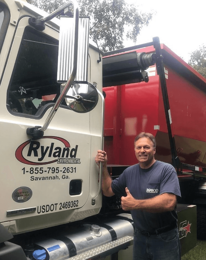 Ryland Environmental roll-off driver with truck ready for delivery