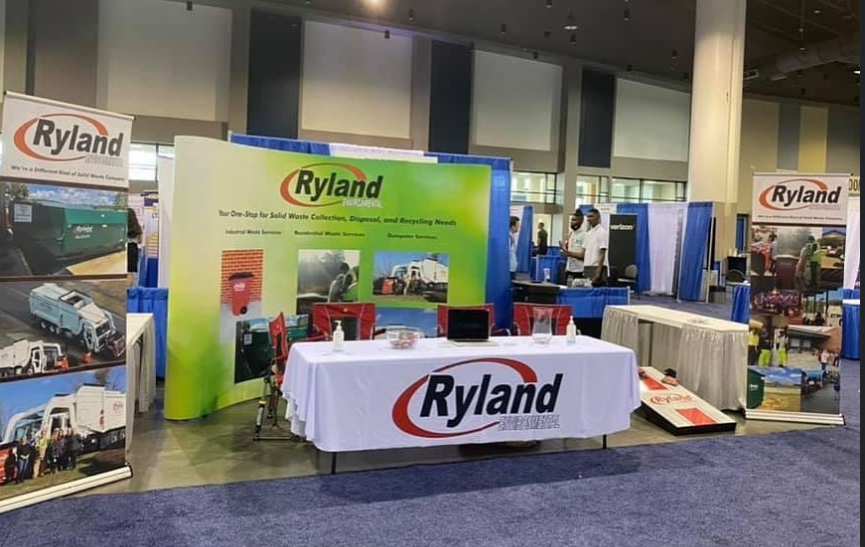 Ryland Environmental trade show booth showcasing industrial waste services, residential carts, and commercial dumpsters